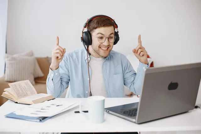 Man talking through headphones during an online conversation.