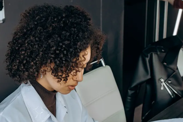 Woman reviewing figures at her desk with a laptop.